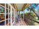 Covered patio with two chairs and screen overlooking the backyard at 1141 Myrtle Rd, Valrico, FL 33596