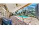 Covered brick patio leading to a sparkling in-ground pool and screened-in enclosure at 1141 Myrtle Rd, Valrico, FL 33596