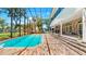 A stunning view of a pool, brick patio, and covered lounge area in the backyard at 1141 Myrtle Rd, Valrico, FL 33596