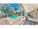 A stunning view of a pool, brick patio, and covered lounge area in the backyard at 1141 Myrtle Rd, Valrico, FL 33596