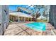 A stunning view of a pool, brick patio, and covered lounge area in the backyard at 1141 Myrtle Rd, Valrico, FL 33596