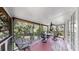 Screened-in porch with seating area overlooks lush foliage and a waterway at 1141 Myrtle Rd, Valrico, FL 33596