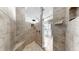 Tiled shower with shower head, shower caddy, and convenient bench seating at 1141 Myrtle Rd, Valrico, FL 33596