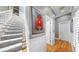 Bright stairway featuring wood railing, plush carpet, and a striking decorative wall hanging at 1141 Myrtle Rd, Valrico, FL 33596