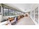 Bright sunroom with carpet flooring, walls with large windows, and ceiling fans with exterior views at 1141 Myrtle Rd, Valrico, FL 33596