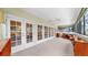 Bright sunroom with carpet flooring, light walls, ceiling fans, and French doors with exterior views at 1141 Myrtle Rd, Valrico, FL 33596