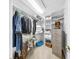 Walk-in closet featuring white shelving, hanging storage, carpet flooring, and a neat organization system at 1141 Myrtle Rd, Valrico, FL 33596