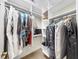 Walk-in closet featuring white shelving, hanging storage, carpet flooring, and plenty of space at 1141 Myrtle Rd, Valrico, FL 33596