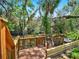 Wooden deck with chairs overlooks a tranquil waterway surrounded by nature at 1141 Myrtle Rd, Valrico, FL 33596