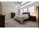 Comfortable bedroom with tray ceiling, ceiling fan, carpet flooring, and two windows to allow for natural light at 12401 Shining Willow St, Riverview, FL 33579