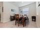Cozy dining area with tile flooring, a wooden table and seating, and a buffet with wine storage at 12401 Shining Willow St, Riverview, FL 33579