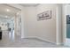 Elegant hallway showcasing neutral walls, ceramic tile flooring and sophisticated decor at 12401 Shining Willow St, Riverview, FL 33579