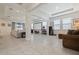 Spacious living room with tile floors, large windows, and a home theater setup with projector screen at 12401 Shining Willow St, Riverview, FL 33579