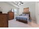 Serene main bedroom with wooden furniture, soft carpet and plenty of natural light at 12401 Shining Willow St, Riverview, FL 33579