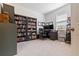 Well-lit office with bookshelves, a work station and neutral carpet at 12401 Shining Willow St, Riverview, FL 33579