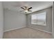 Bright bedroom with a ceiling fan and a window offering natural light at 12617 Maple Bonsai Dr, Riverview, FL 33579