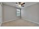 This bedroom features a ceiling fan and a window offering natural light at 12617 Maple Bonsai Dr, Riverview, FL 33579