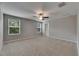 Neutral carpeted bedroom with a ceiling fan and window providing natural light at 12617 Maple Bonsai Dr, Riverview, FL 33579