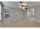 Bright bonus room with carpet flooring and ample natural light, complemented by a ceiling fan at 12617 Maple Bonsai Dr, Riverview, FL 33579