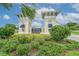 Triple Creek community entrance featuring decorative towers, signage, and lush landscaping at 12617 Maple Bonsai Dr, Riverview, FL 33579