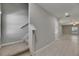 Hallway with stairs and tile flooring leading to an open living space at 12617 Maple Bonsai Dr, Riverview, FL 33579