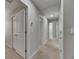 Hallway featuring carpet flooring, light-grey walls, white doors and recessed lighting at 12617 Maple Bonsai Dr, Riverview, FL 33579