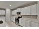 Bright kitchen featuring stainless steel appliances, white cabinets, and light countertops at 12617 Maple Bonsai Dr, Riverview, FL 33579