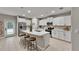 Modern kitchen with stainless steel appliances, white cabinets, and an island with seating at 12617 Maple Bonsai Dr, Riverview, FL 33579