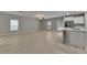 Open concept living room and kitchen with tile floors and ample natural light at 12617 Maple Bonsai Dr, Riverview, FL 33579