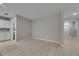 Open-concept living room and kitchen area with neutral walls and tile floors at 12617 Maple Bonsai Dr, Riverview, FL 33579
