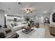 Bright, open living room features a ceiling fan, neutral color palette, and modern furnishings at 12617 Maple Bonsai Dr, Riverview, FL 33579
