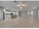 Spacious living room with modern tile flooring open to the white kitchen at 12617 Maple Bonsai Dr, Riverview, FL 33579