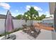 Beautiful backyard featuring relaxing lounge chairs, an umbrella, and a view of above ground pool at 12804 Bert Pl, Tampa, FL 33625