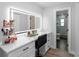 Bathroom vanity with a lighted mirror and a marble countertop, adjacent to the walk-in shower area at 12804 Bert Pl, Tampa, FL 33625
