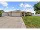 Charming single-story home with a well-manicured lawn, driveway and inviting curb appeal at 12804 Bert Pl, Tampa, FL 33625