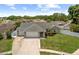 Attractive single-story home featuring a three-car garage, pristine landscaping, and a fenced yard at 12804 Bert Pl, Tampa, FL 33625