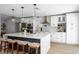 The modern kitchen features a large island, stainless steel appliances, and white cabinetry with marble countertops at 12804 Bert Pl, Tampa, FL 33625