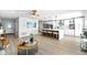 Open-concept living room with modern furnishings and hardwood floors, flowing into the kitchen at 12804 Bert Pl, Tampa, FL 33625