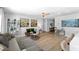 Comfortable living room featuring a plush sofa, stylish decor, and hardwood floors at 12804 Bert Pl, Tampa, FL 33625