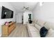 Spacious living room featuring a large comfortable couch, modern decor, and plank flooring at 12804 Bert Pl, Tampa, FL 33625