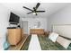 This primary bedroom includes a ceiling fan and an array of wooden furniture providing ample storage space at 12804 Bert Pl, Tampa, FL 33625