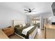 Tranquil primary bedroom featuring a ceiling fan and sliding door access to a patio and outdoor seating area at 12804 Bert Pl, Tampa, FL 33625