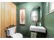 Stylish powder room featuring modern fixtures, vanity, and wood accent wall at 12804 Bert Pl, Tampa, FL 33625