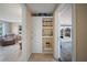 Hallway with a well stocked bar, with shelving, cabinets, glassware, and bottles at 12901 College Hill Dr, Hudson, FL 34667