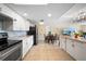 Spacious open-plan kitchen with stainless appliances, adjacent dining area, and access to a living space at 12901 College Hill Dr, Hudson, FL 34667