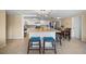Open kitchen features a central island with seating, stainless steel appliances, and a dining table at 12901 College Hill Dr, Hudson, FL 34667