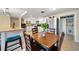 Bright, updated kitchen with dining area, stainless steel refrigerator, and custom white cabinetry at 12901 College Hill Dr, Hudson, FL 34667