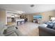 Open-concept layout with kitchen island seating, dining area, and a comfortable living room setup at 12901 College Hill Dr, Hudson, FL 34667