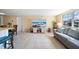 Comfortable living area adjacent to kitchen featuring a large window and modern furnishings at 12901 College Hill Dr, Hudson, FL 34667