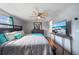 Bedroom with hardwood floors, ceiling fan and TV, dresser with mirror and closet space at 12901 College Hill Dr, Hudson, FL 34667